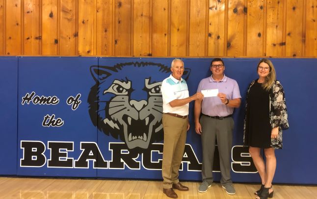 Bill Fanning and Kelli Seacat present Fargo Gage Superintendent, Mike Jones, a check